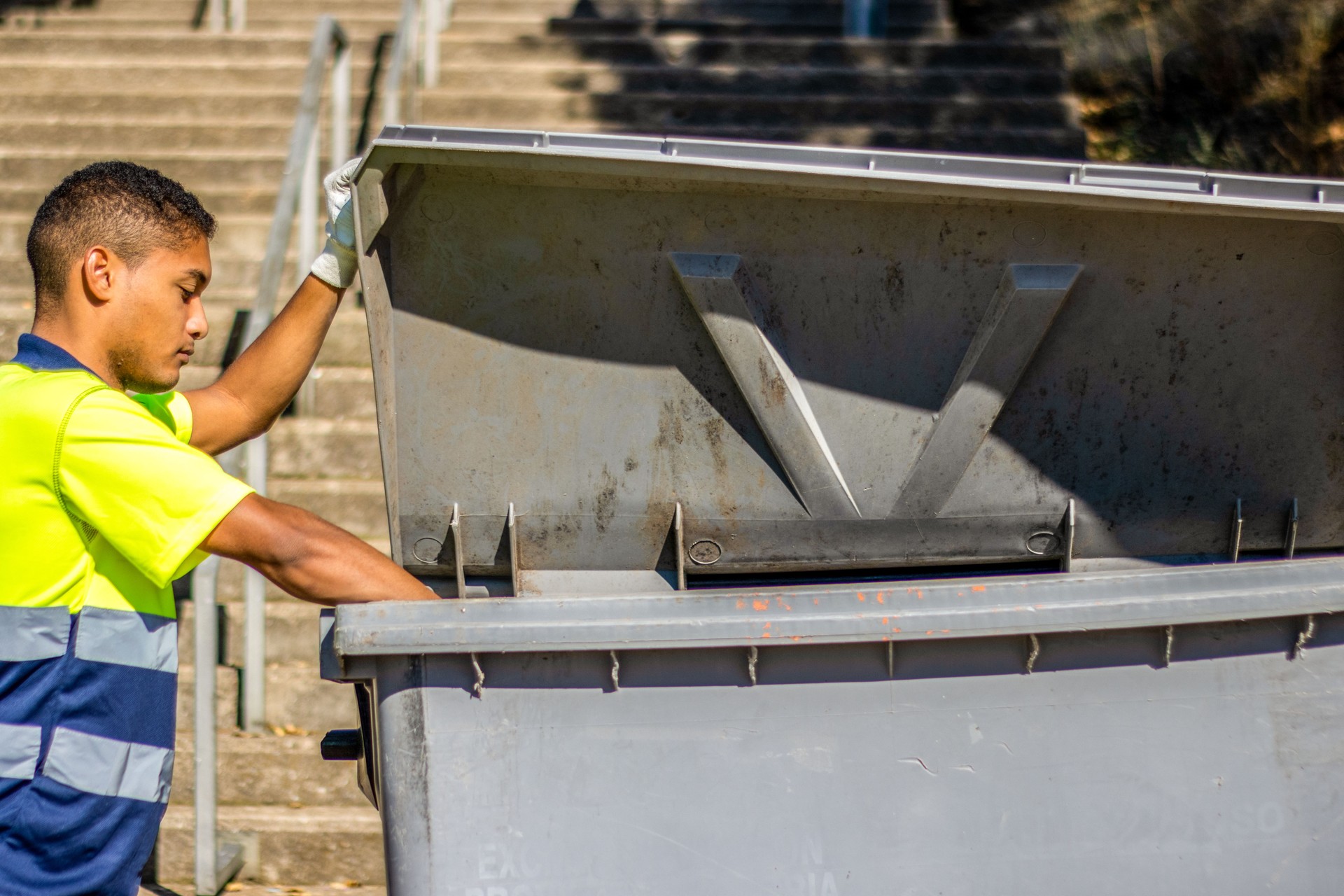 Man putting garbage bag in the trash can. Person putting garbage bags in place